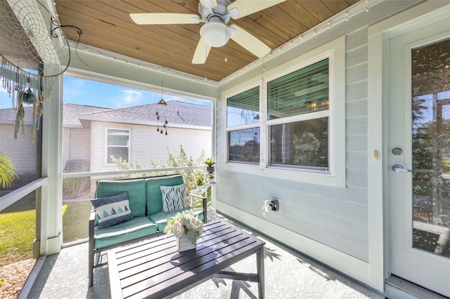 sunroom featuring an outdoor living space and a ceiling fan