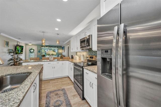 kitchen featuring tasteful backsplash, recessed lighting, appliances with stainless steel finishes, white cabinets, and a sink