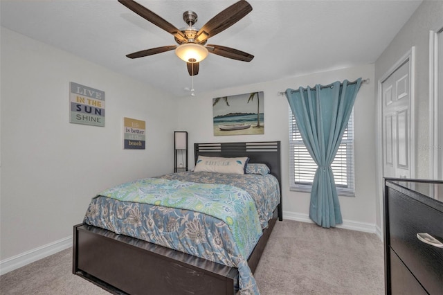 carpeted bedroom featuring baseboards and ceiling fan