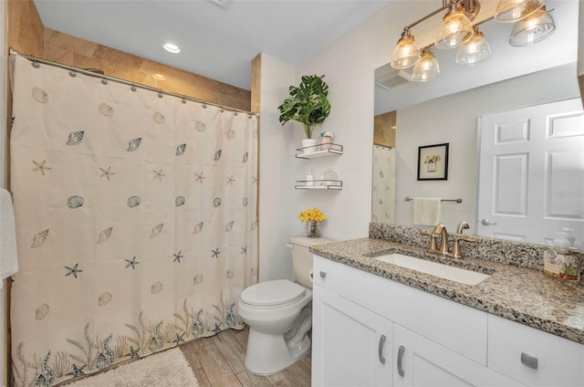 full bathroom with toilet, vanity, a shower with curtain, and wood finished floors