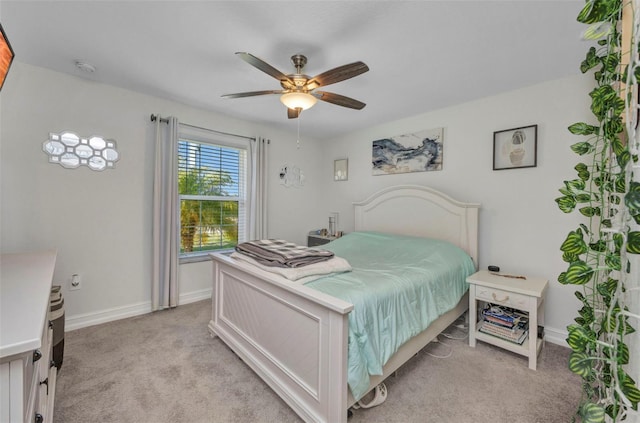 bedroom featuring baseboards, a ceiling fan, and light carpet