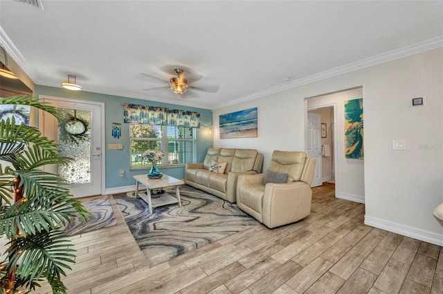 living area with wood finished floors, ornamental molding, and baseboards