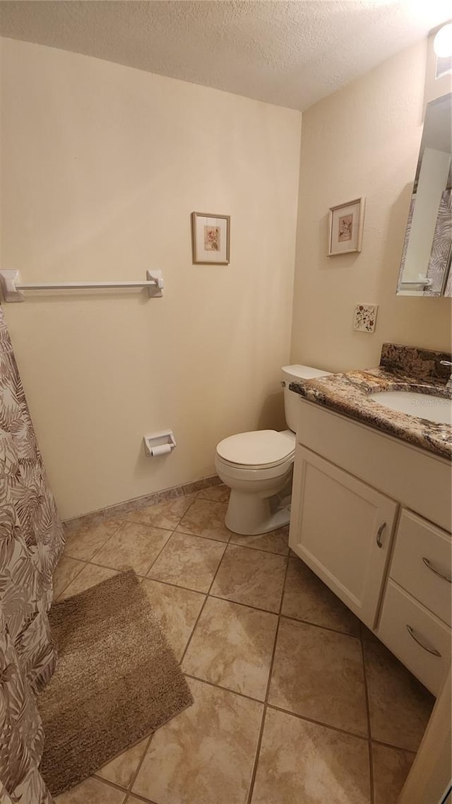 21300 Brinson Ave Unit 201, Port Charlotte, FL 33952 - full bath featuring toilet, a textured ceiling, tile patterned flooring, and vanity