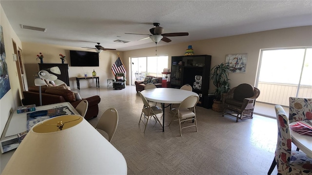 21300 Brinson Ave Unit 201, Port Charlotte, FL 33952 - dining room with visible vents, ceiling fan, and tile patterned floors