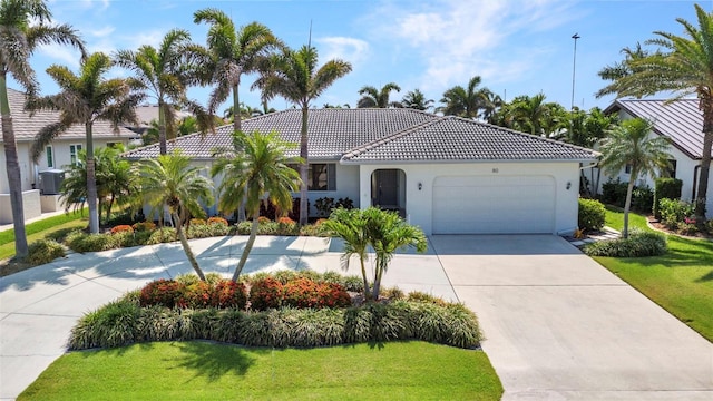 80 Hibiscus Dr, Punta Gorda, FL 33950 - mediterranean / spanish home featuring an attached garage, a front lawn, concrete driveway, and a tiled roof