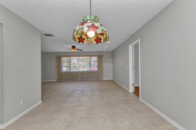 80 Hibiscus Dr, Punta Gorda, FL 33950 - unfurnished room featuring ceiling fan, baseboards, and a textured ceiling