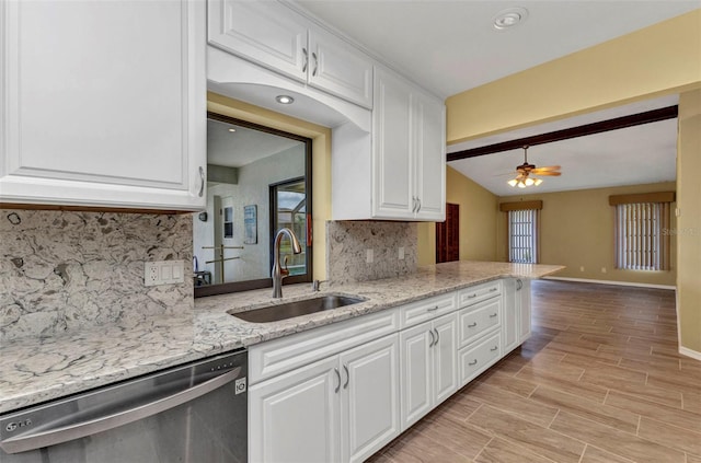 80 Hibiscus Dr, Punta Gorda, FL 33950 - kitchen featuring stainless steel dishwasher, a sink, decorative backsplash, white cabinets, and vaulted ceiling