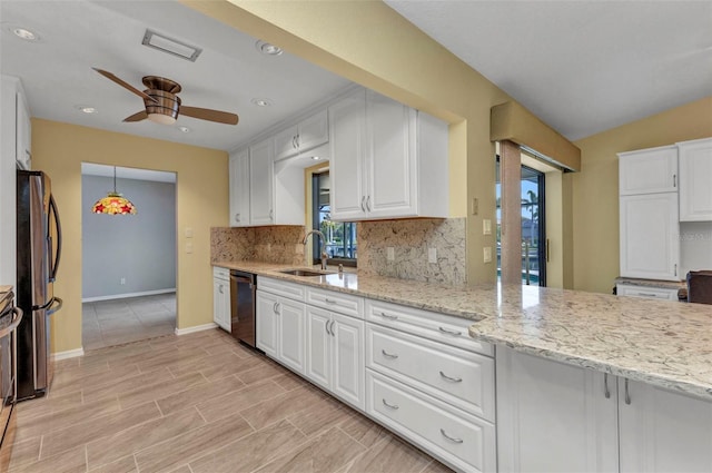 80 Hibiscus Dr, Punta Gorda, FL 33950 - kitchen with stainless steel appliances, a sink, a ceiling fan, white cabinetry, and backsplash