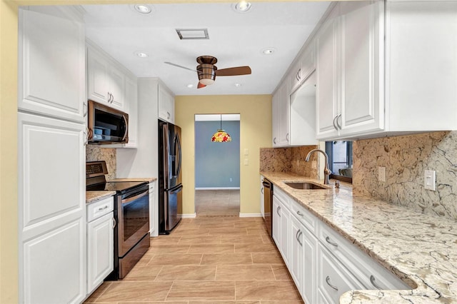 80 Hibiscus Dr, Punta Gorda, FL 33950 - kitchen with stainless steel appliances, a sink, a ceiling fan, white cabinets, and recessed lighting
