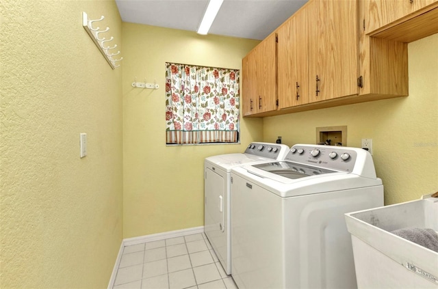 80 Hibiscus Dr, Punta Gorda, FL 33950 - washroom with cabinet space, independent washer and dryer, baseboards, light tile patterned floors, and a textured wall