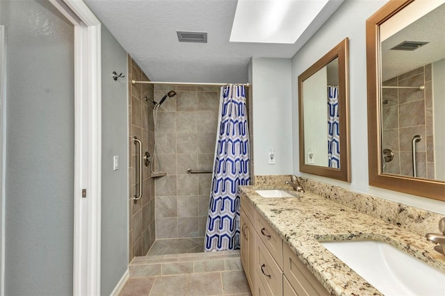80 Hibiscus Dr, Punta Gorda, FL 33950 - bathroom with tiled shower, double vanity, and a textured ceiling