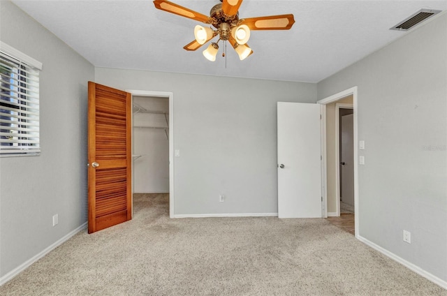80 Hibiscus Dr, Punta Gorda, FL 33950 - unfurnished bedroom with carpet floors, a spacious closet, baseboards, and ceiling fan
