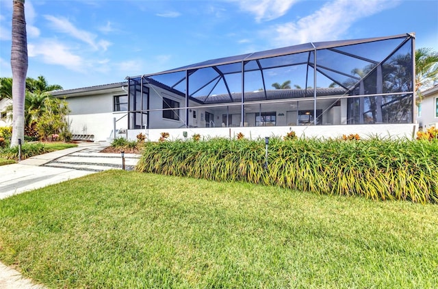 80 Hibiscus Dr, Punta Gorda, FL 33950 - view of front of home featuring a front yard, glass enclosure, and stucco siding