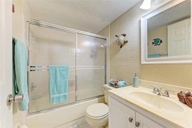 bathroom with a textured ceiling, a textured wall, bath / shower combo with glass door, and toilet
