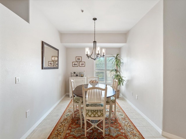 dining space featuring a chandelier, baseboards, and light tile patterned floors