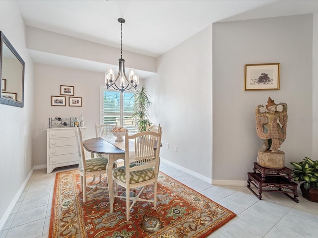 dining area with light tile patterned floors, a notable chandelier, and baseboards