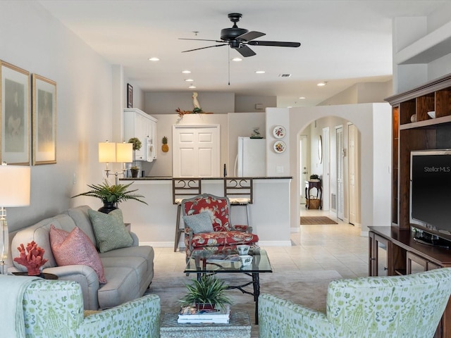 living room featuring recessed lighting, arched walkways, ceiling fan, and light tile patterned floors