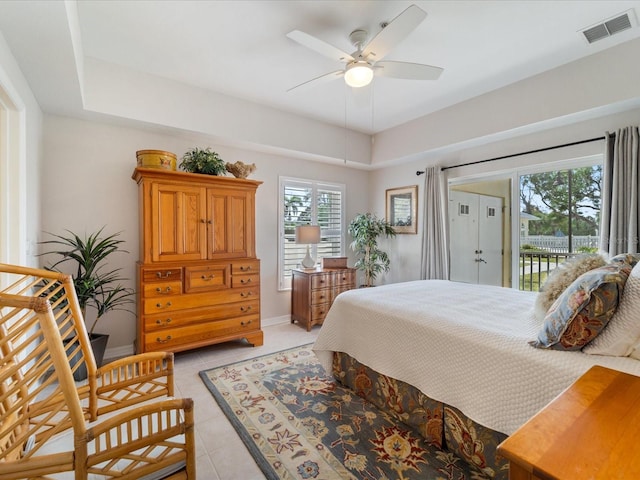 bedroom with light tile patterned flooring, visible vents, access to exterior, and multiple windows