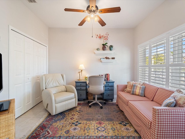 tiled office featuring ceiling fan