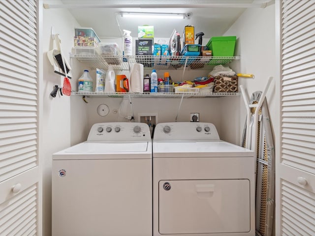 laundry area with washing machine and clothes dryer and laundry area