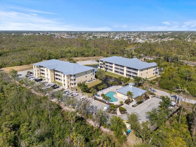 bird's eye view with a wooded view