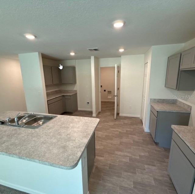 37 Packard Ln, Palm Coast, FL 32164 - kitchen with visible vents, gray cabinetry, baseboards, a sink, and recessed lighting