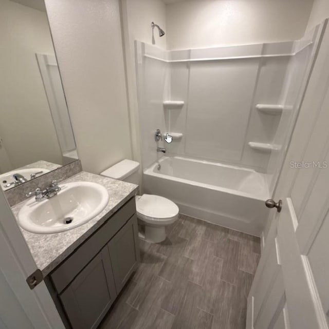 37 Packard Ln, Palm Coast, FL 32164 - bathroom with toilet, washtub / shower combination, wood finished floors, and vanity