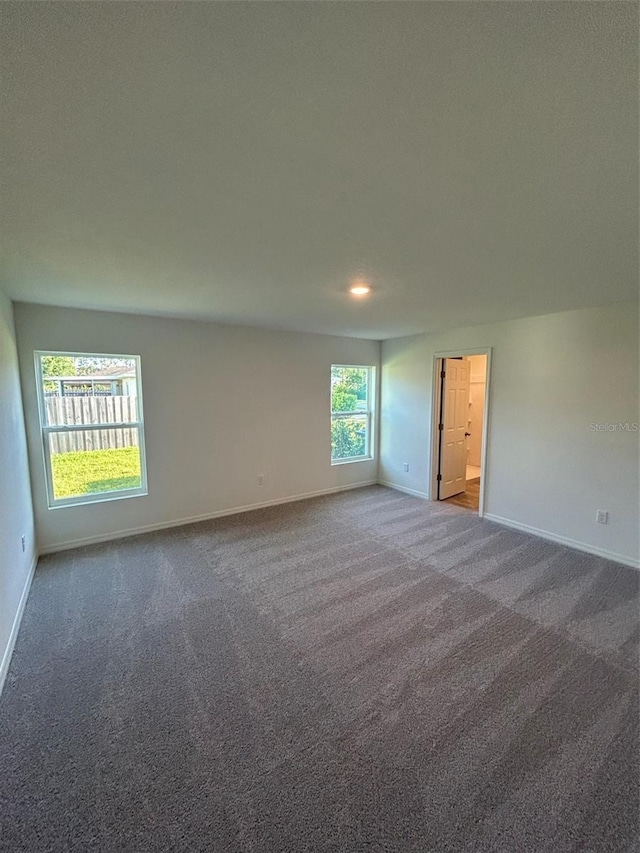 11 Zorro Ct, Palm Coast, FL 32164 - spare room featuring baseboards and carpet