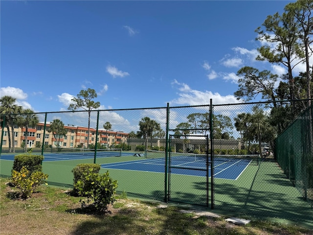 view of tennis court featuring fence