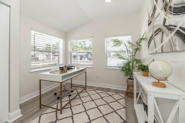 office area with wood finished floors, lofted ceiling, and baseboards