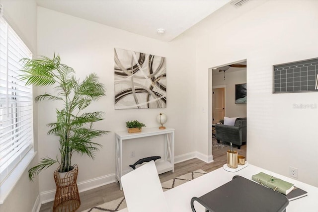 living area with wood finished floors and baseboards
