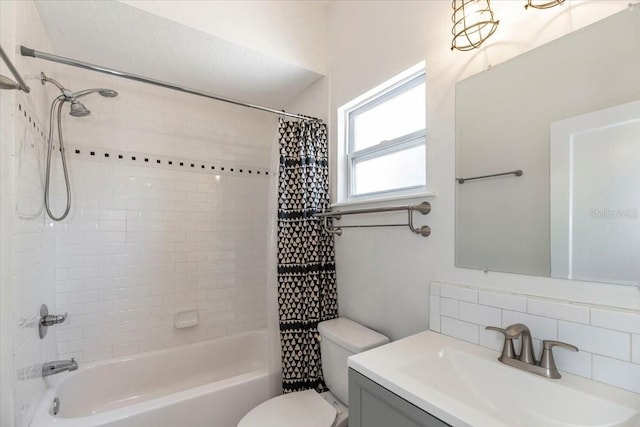full bath with tasteful backsplash, shower / bath combo with shower curtain, toilet, and vanity