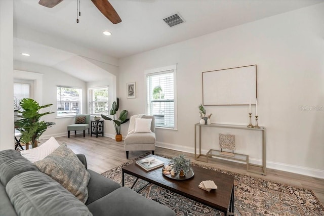 living area with visible vents, wood finished floors, and a healthy amount of sunlight