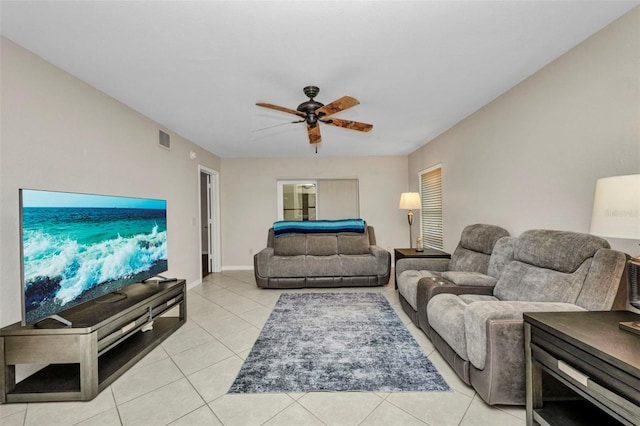 living area with ceiling fan, visible vents, and light tile patterned floors