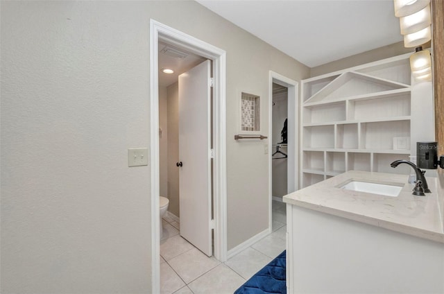 bathroom featuring toilet, tile patterned flooring, and vanity