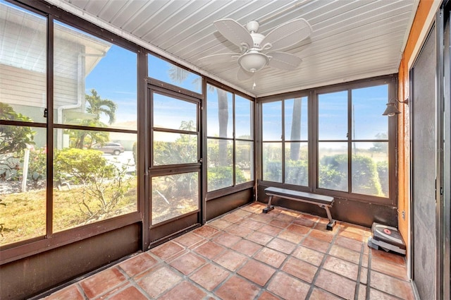 unfurnished sunroom featuring ceiling fan