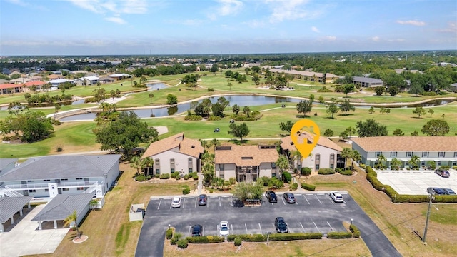 bird's eye view with a water view, view of golf course, and a residential view