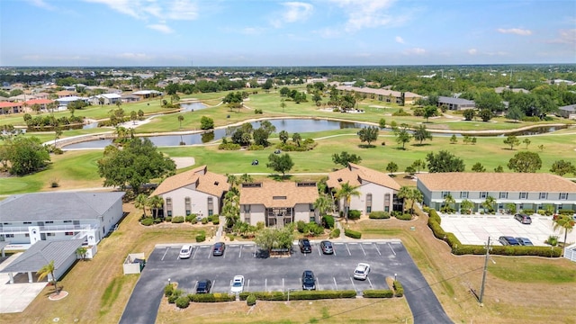bird's eye view with a water view, view of golf course, and a residential view