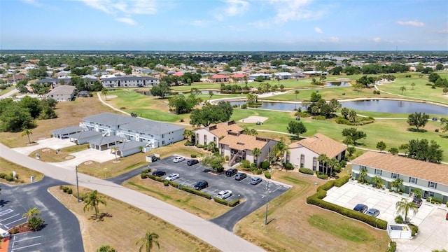 aerial view with a residential view, view of golf course, and a water view