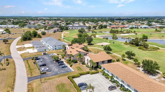 birds eye view of property with a water view, a residential view, and golf course view