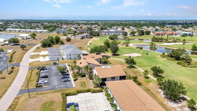aerial view with a residential view, view of golf course, and a water view