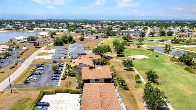aerial view with a water view, view of golf course, and a residential view