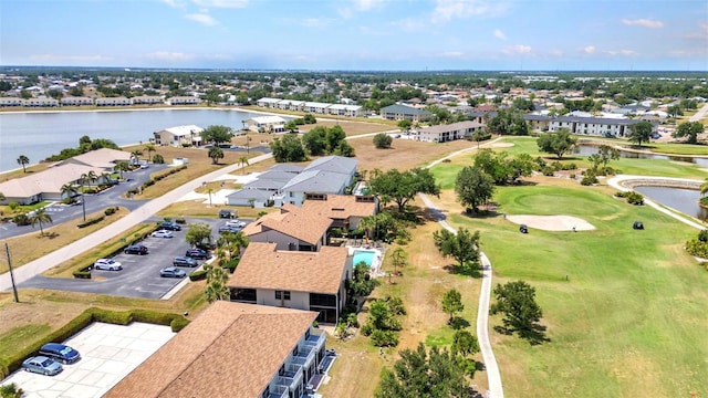bird's eye view with a residential view, a water view, and golf course view