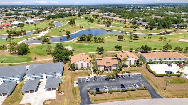 birds eye view of property with a residential view, view of golf course, and a water view