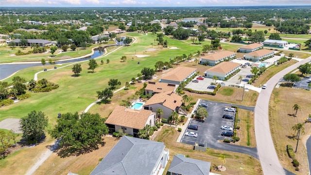 birds eye view of property featuring a water view, view of golf course, and a residential view