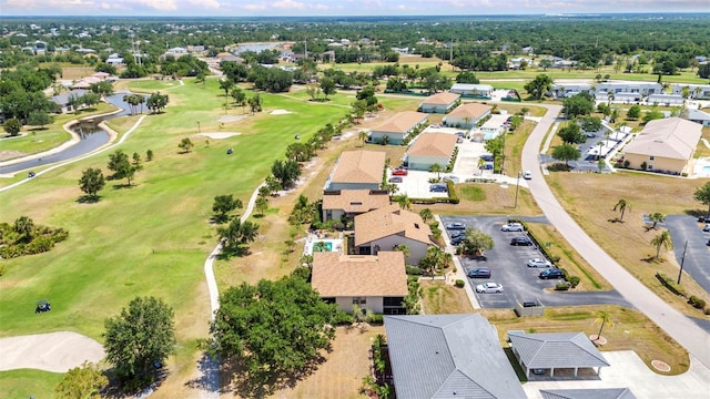 birds eye view of property with a water view, a residential view, and golf course view
