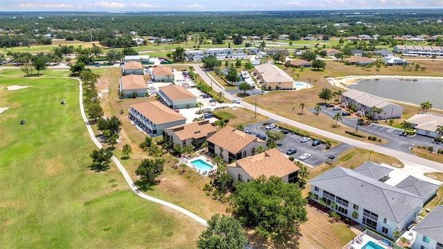 drone / aerial view with a residential view and a water view