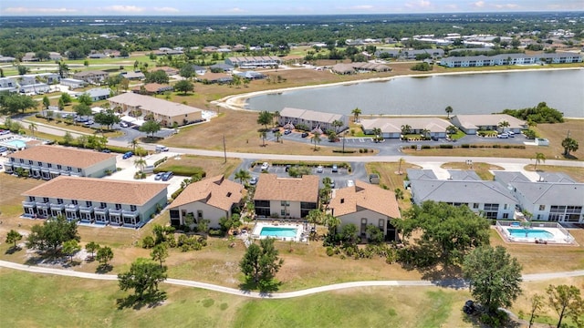 birds eye view of property with a water view and a residential view