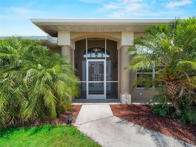 2288 Prague Ln, Punta Gorda, FL 33983 - view of exterior entry featuring french doors and stucco siding