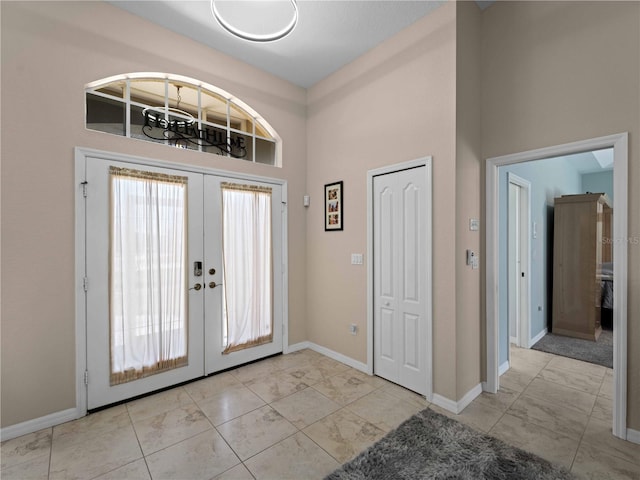 2288 Prague Ln, Punta Gorda, FL 33983 - entrance foyer featuring baseboards, french doors, marble finish floor, and a towering ceiling